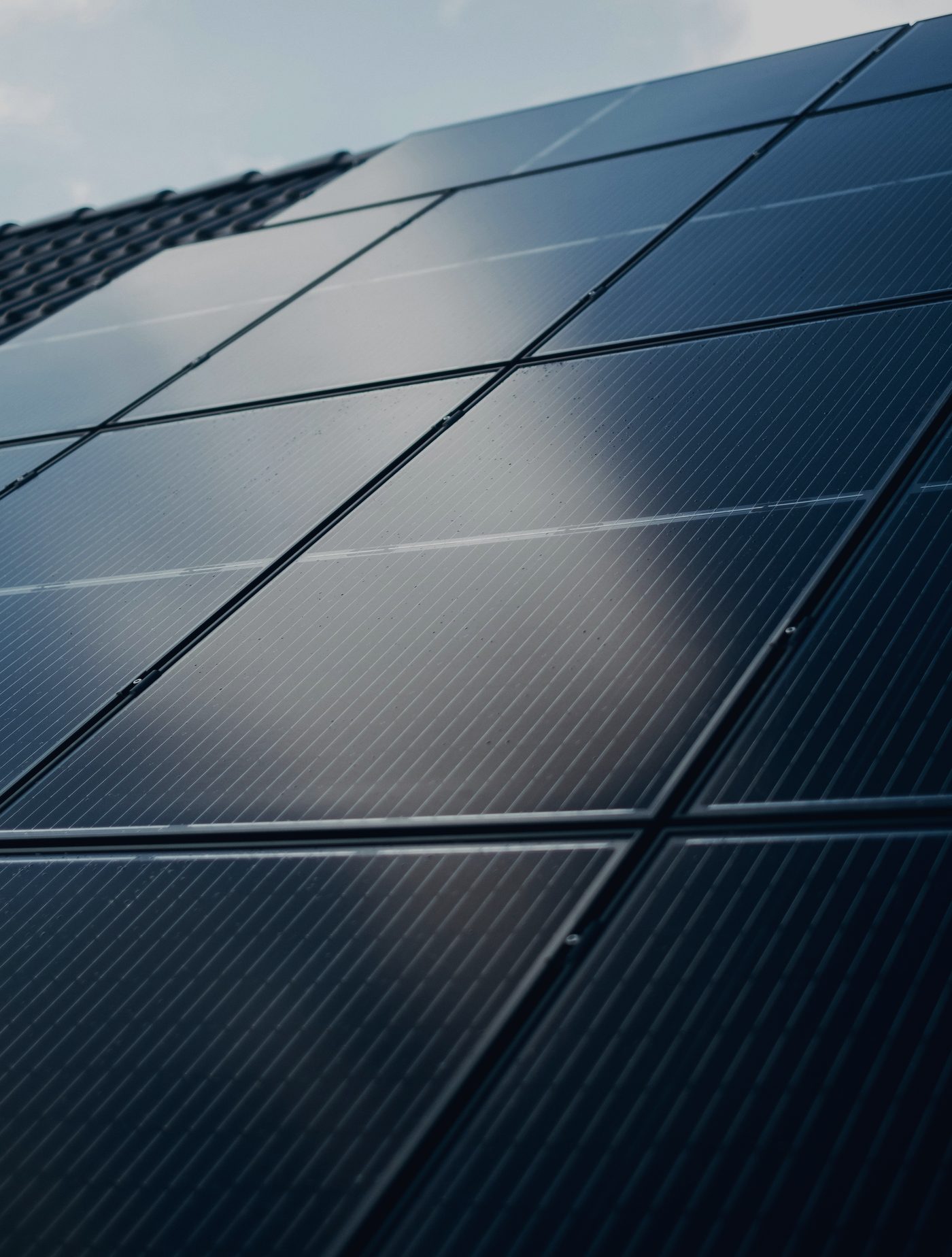 Close-up of black solar panels on a residential roof
